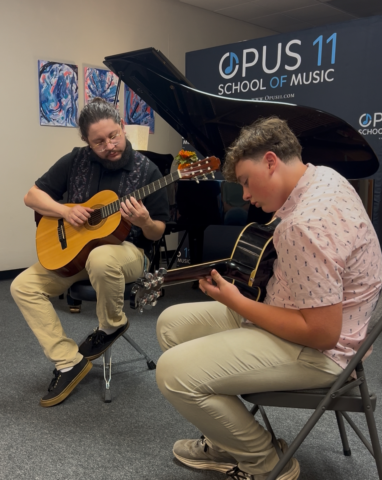 Guitar instructor and student in a one-on-one lesson at Opus11